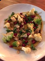 Florets of cauliflower served with tahini, almonds and pomegranate