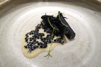 Salsify Cooked in squid ink, caviar sauce, elderflower butter sauce