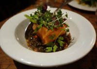 Warm confit of salmon with duck, put lentils and herbs