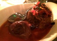 Braised lamb shoulder and red oions with orange zest, tomatoes and olives