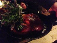 The roast chicken for two (with foie gras and black truffle) presented at the table at Nomad