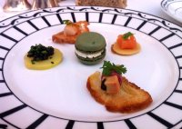 A selection to canapes, including olive oil macaroon, blini with smoked salmon and ratte potato with caviar