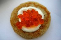 Blini loaded with sour cream and keta caviar