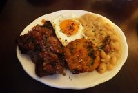 Fiestita de Bavette bavette steak, fried Burford Brown egg, rocoto salsa, plantain tacacho, cannellini beans with cured pork