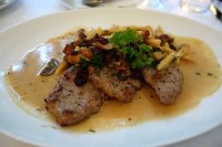 Sauteed veal escalopes with fried koptyka mushrooms and cranberries