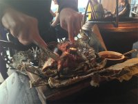 Cutting up the aromatic beef rib braised in lotus leaf