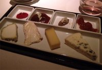 Assortment of four French cheeses, country bread and condiments